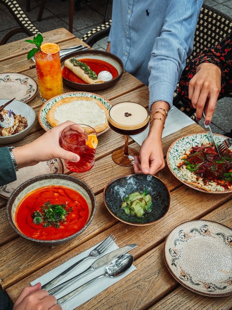 A shared table with Hungarian dishes and drinks at Kismező